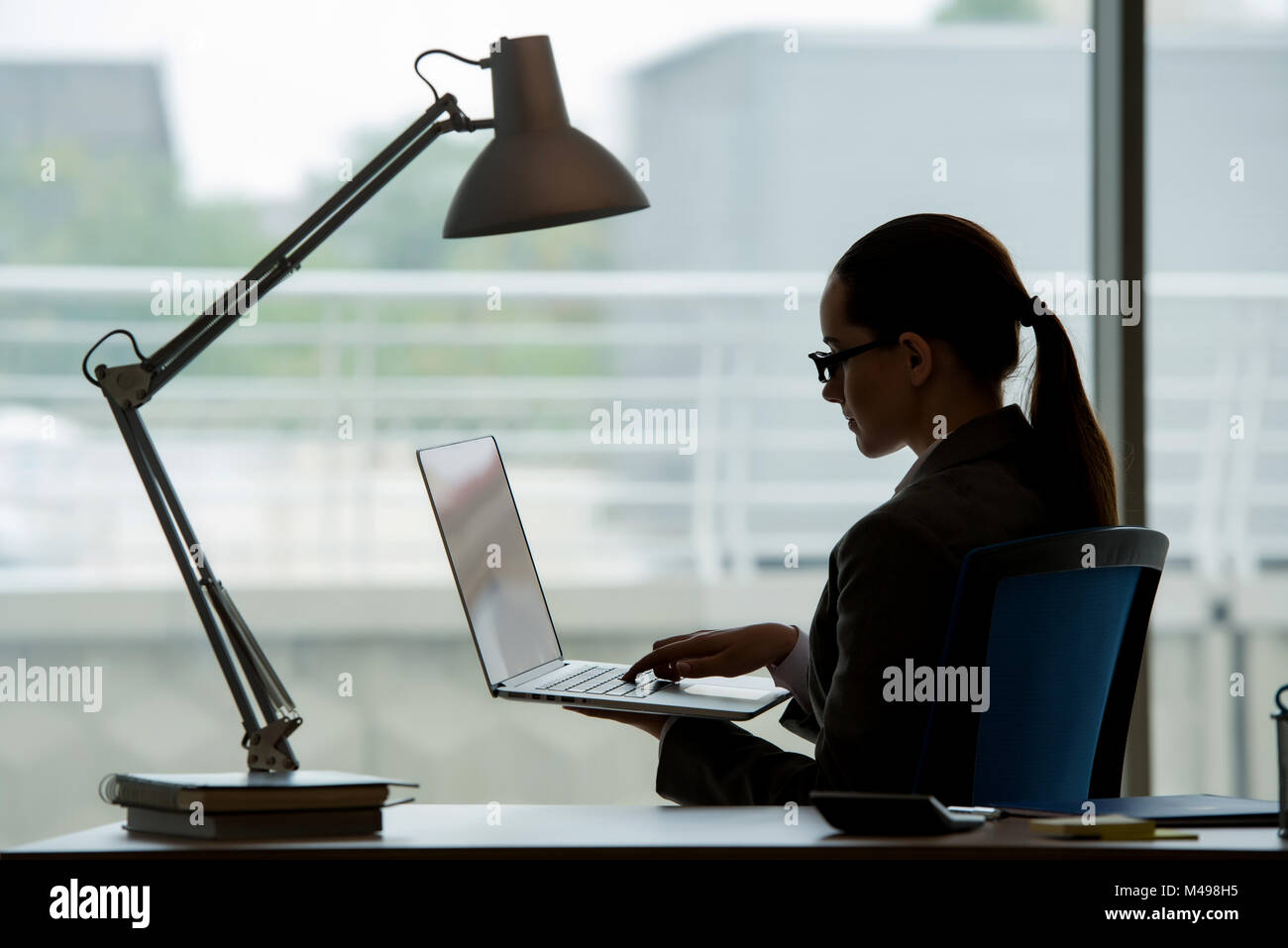 Businesswoman working at her desk Stock Photo - Alamy