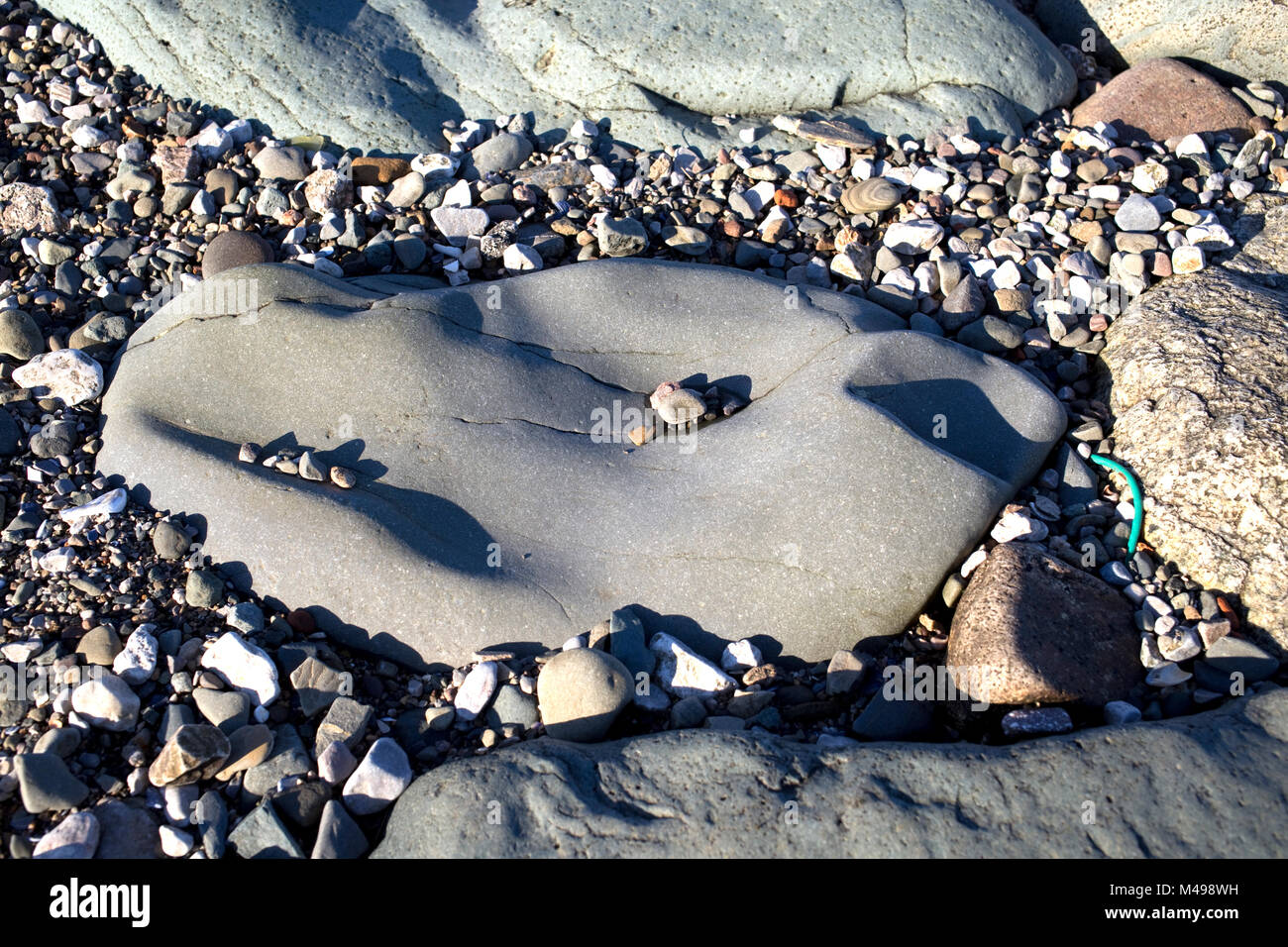 Smooth pebble eroded by wave action Roa Island Cumbria UK Stock Photo