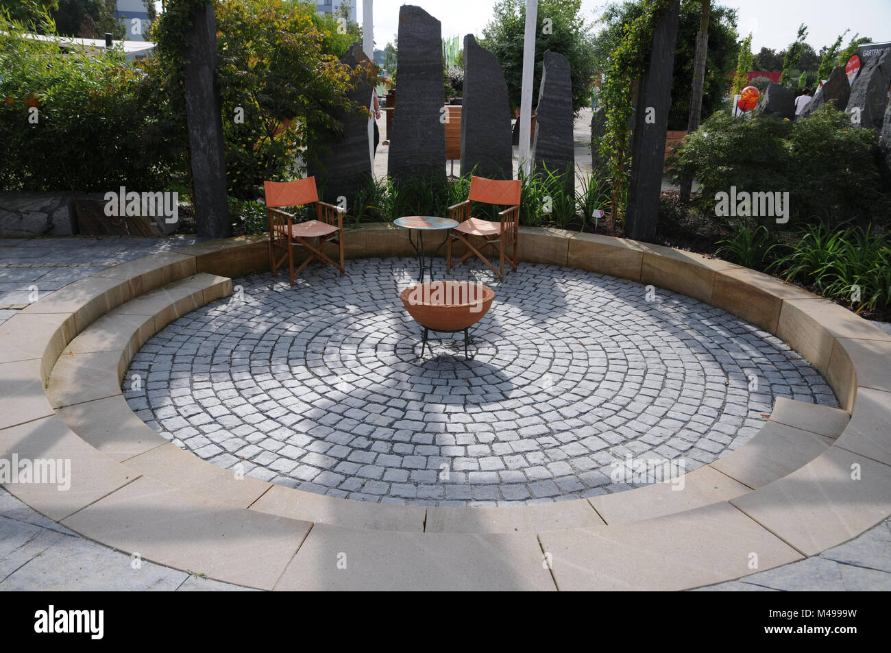 Garden with terrace, granite-pavement and fire-place Stock Photo