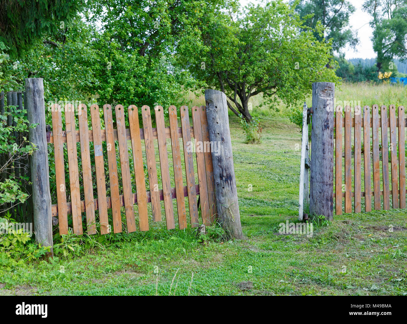 rickety fence in the countryside a summer day Stock Photo