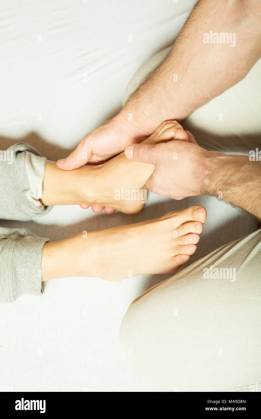 A young adult woman receiving a foot massage Stock Photo Alamy
