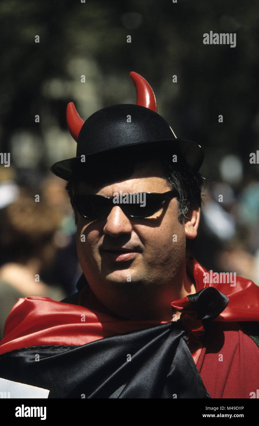 Protester in red and black with a hat with horns at an anti-globalisation protest in Barcelona in March 2001 Stock Photo