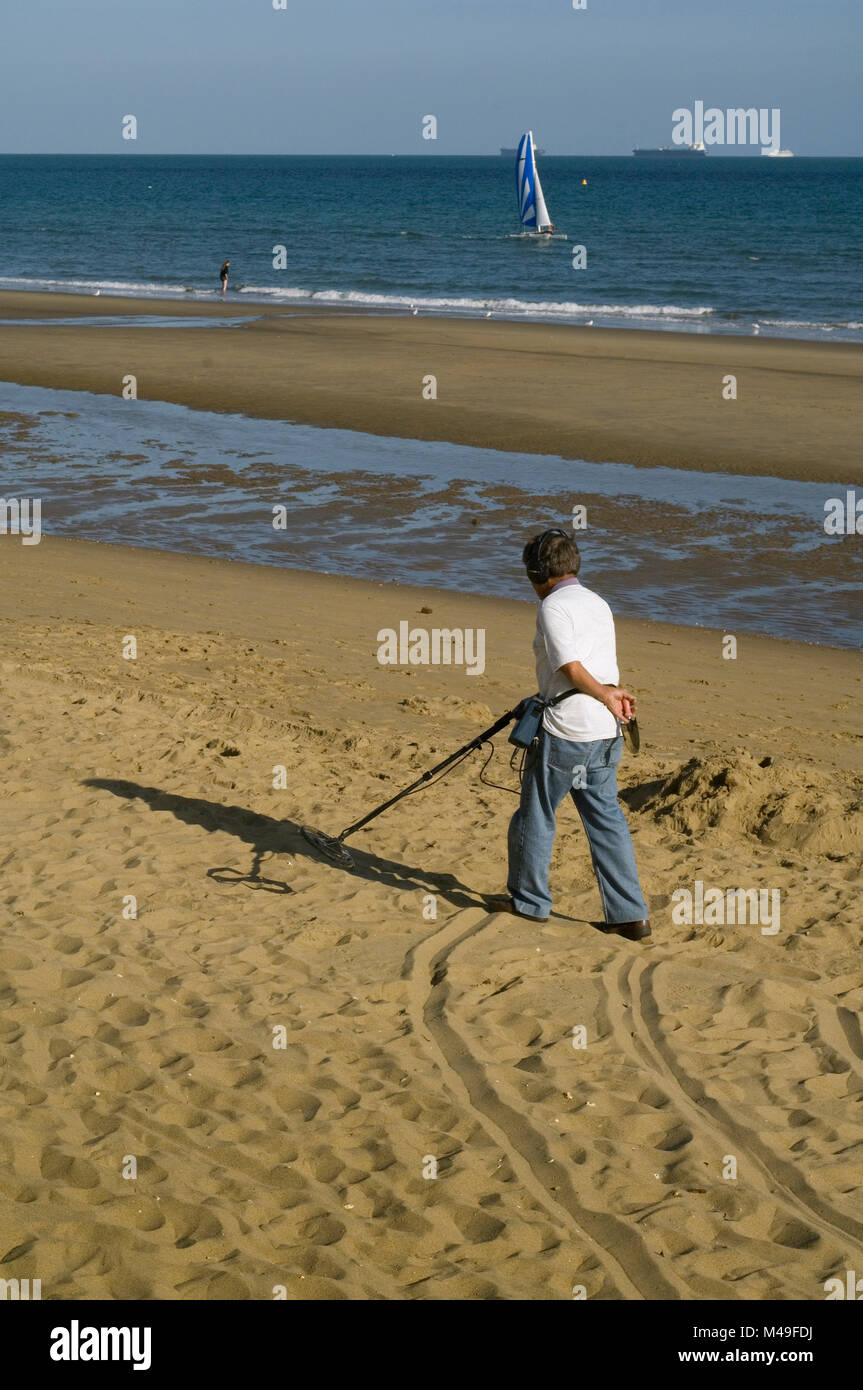 Treasure hunter with metal detector on a beach in the Isle of Wight