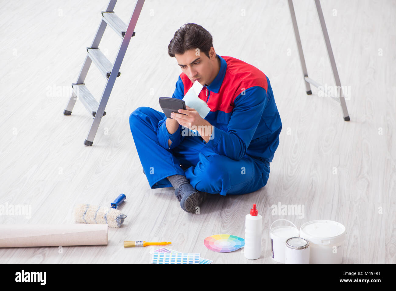 Young painter trying to match colours for painting job Stock Photo Alamy