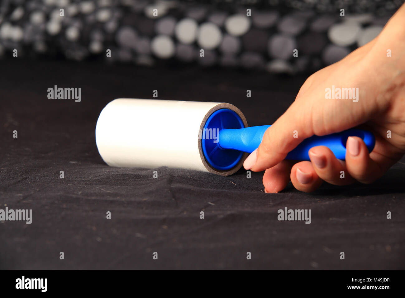 Cleaning dirty bed sheet with wool with cleaning roller closeup Stock Photo