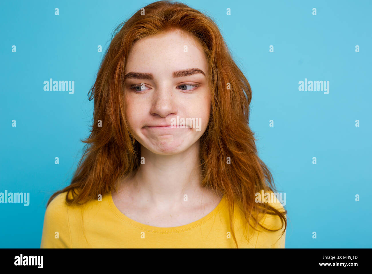 Headshot Portrait of tender redhead teenage girl with serious ...