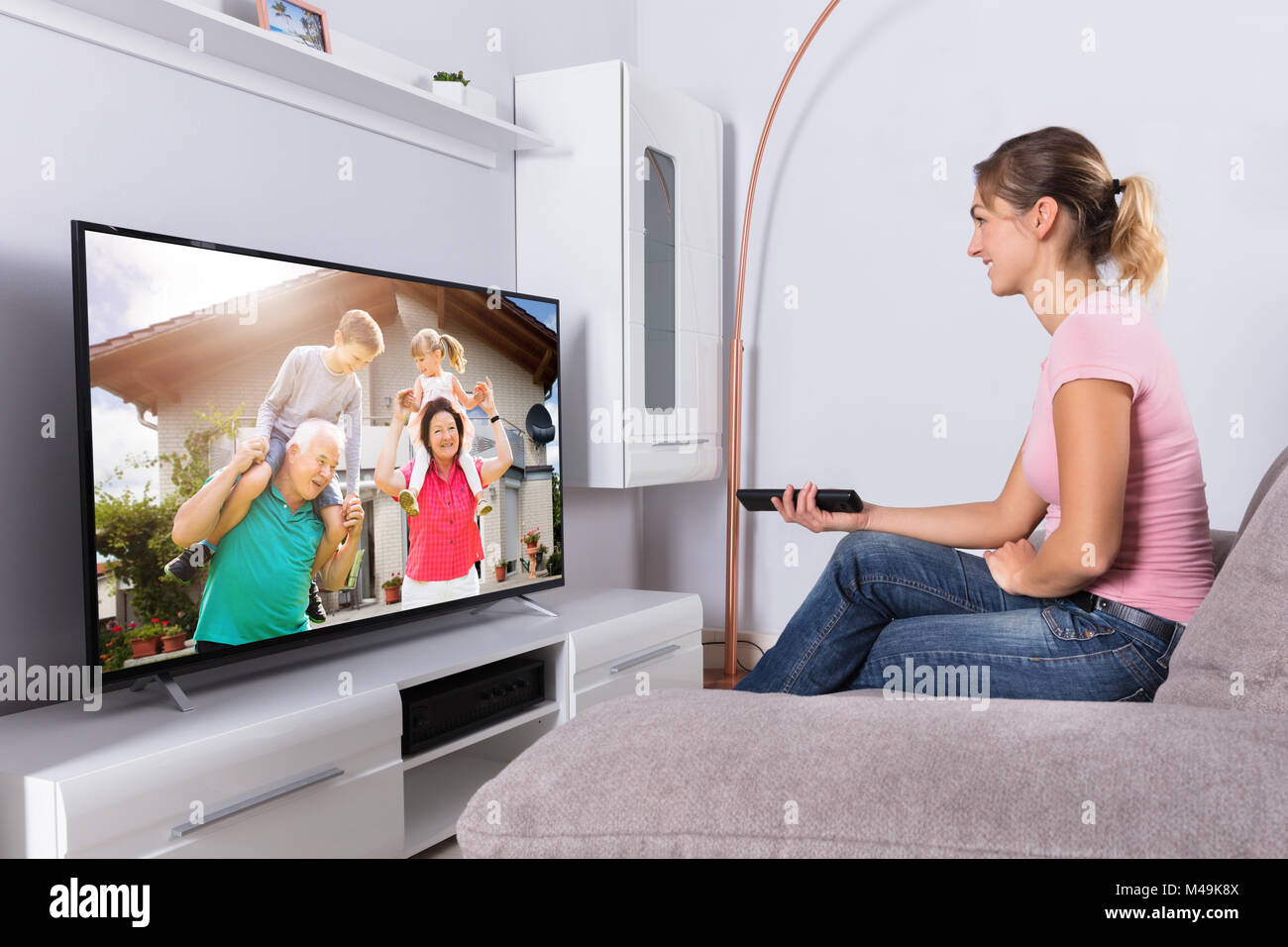 Young Happy Woman Watching Movie On Television At Home Stock Photo - Alamy