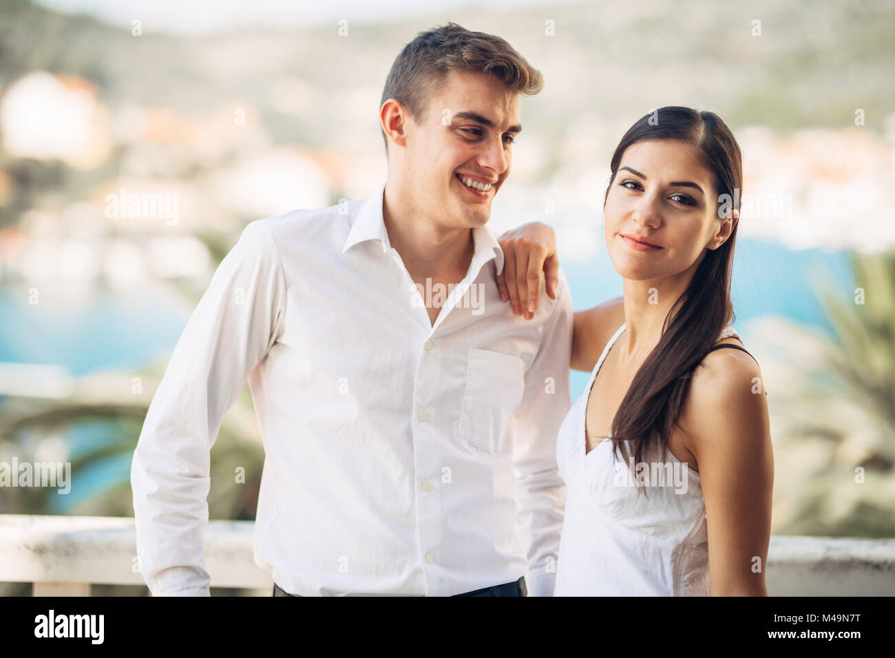Young couple visiting tropical holiday resort.Honeymoon.Couple vacation. Woman looking at another man while with her husband/boyfriend.Cheating.Summer Stock Photo