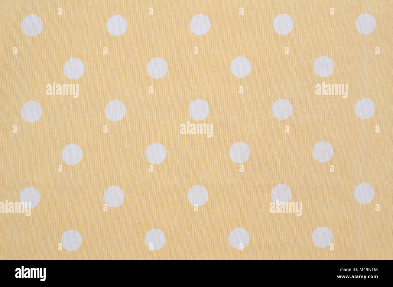 Kitchen yellow table cloth texture fabric with white dots Stock Photo