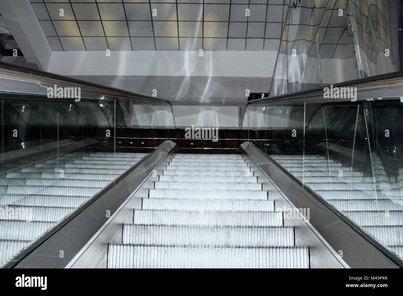 Empty escalator stairs moving up in modern office building Stock Photo