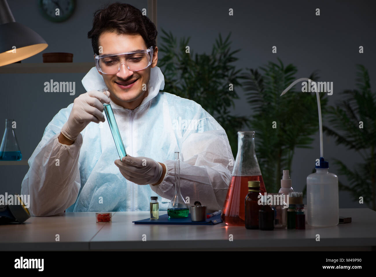 Young male lab chemist late at night in overtime time Stock Photo Alamy