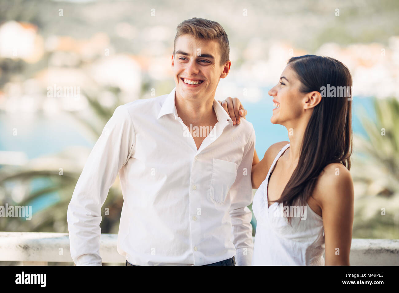 Happy couple in love on a summer holiday vacation.Celebrating holiday,anniversary,engagement. Successful man in relationship with beautiful woman Stock Photo