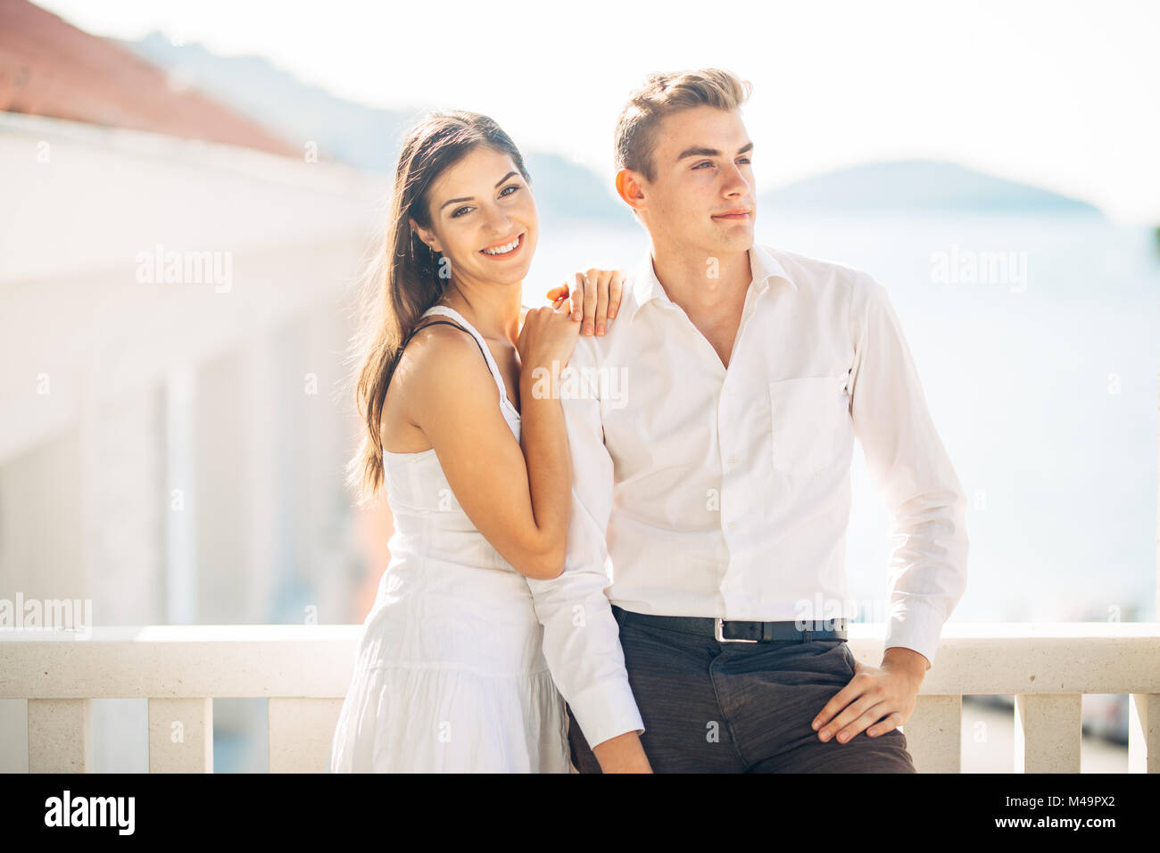Attractive couple looking at amazing sea view.Enjoying sun and sunny weather and breathing in fresh ocean air.Enjoying moment outside.Two people shari Stock Photo