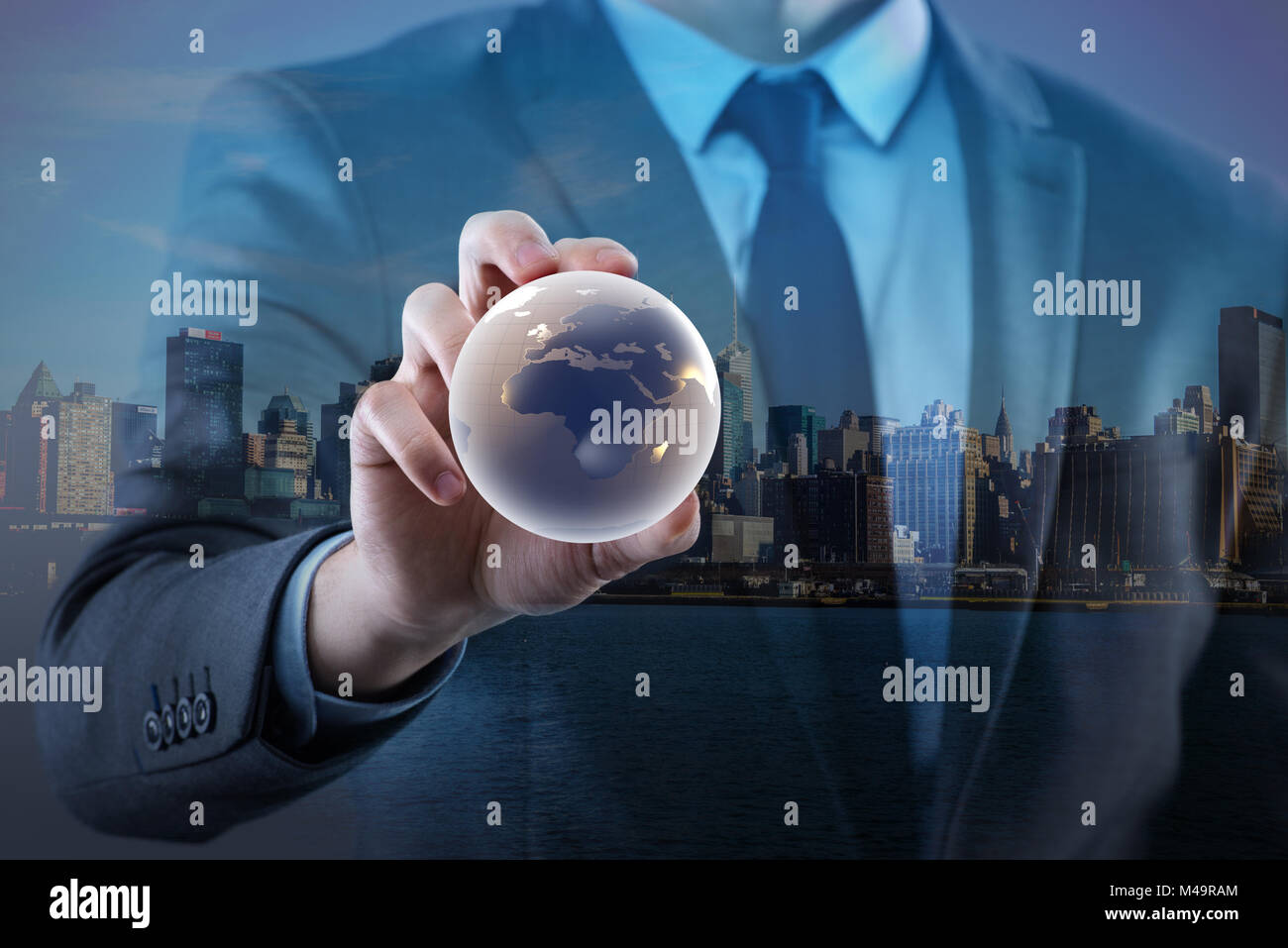 Businessman holding globe in global business concept Stock Photo - Alamy