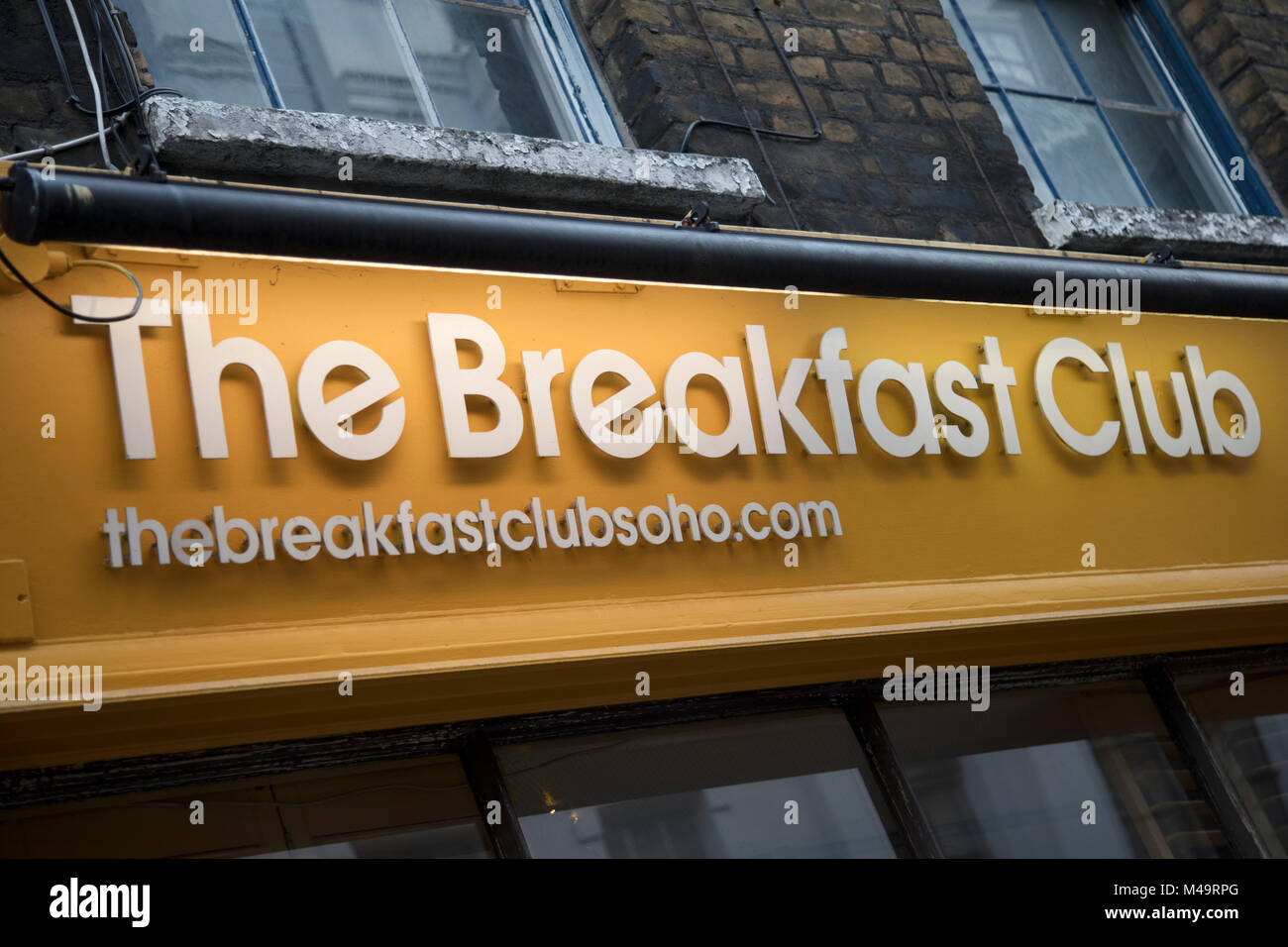 Sign for The Breakfast Club restaurant in Soho, London, England, United Kingdom. The Breakfast Club is incredibly popular amongst young people who are seen queueing outside at each of the sites of this trendy cafe, although they insist this should be known as a caf. Stock Photo