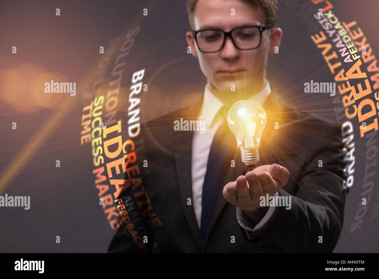 Young businessman with light bulb in idea concept Stock Photo - Alamy