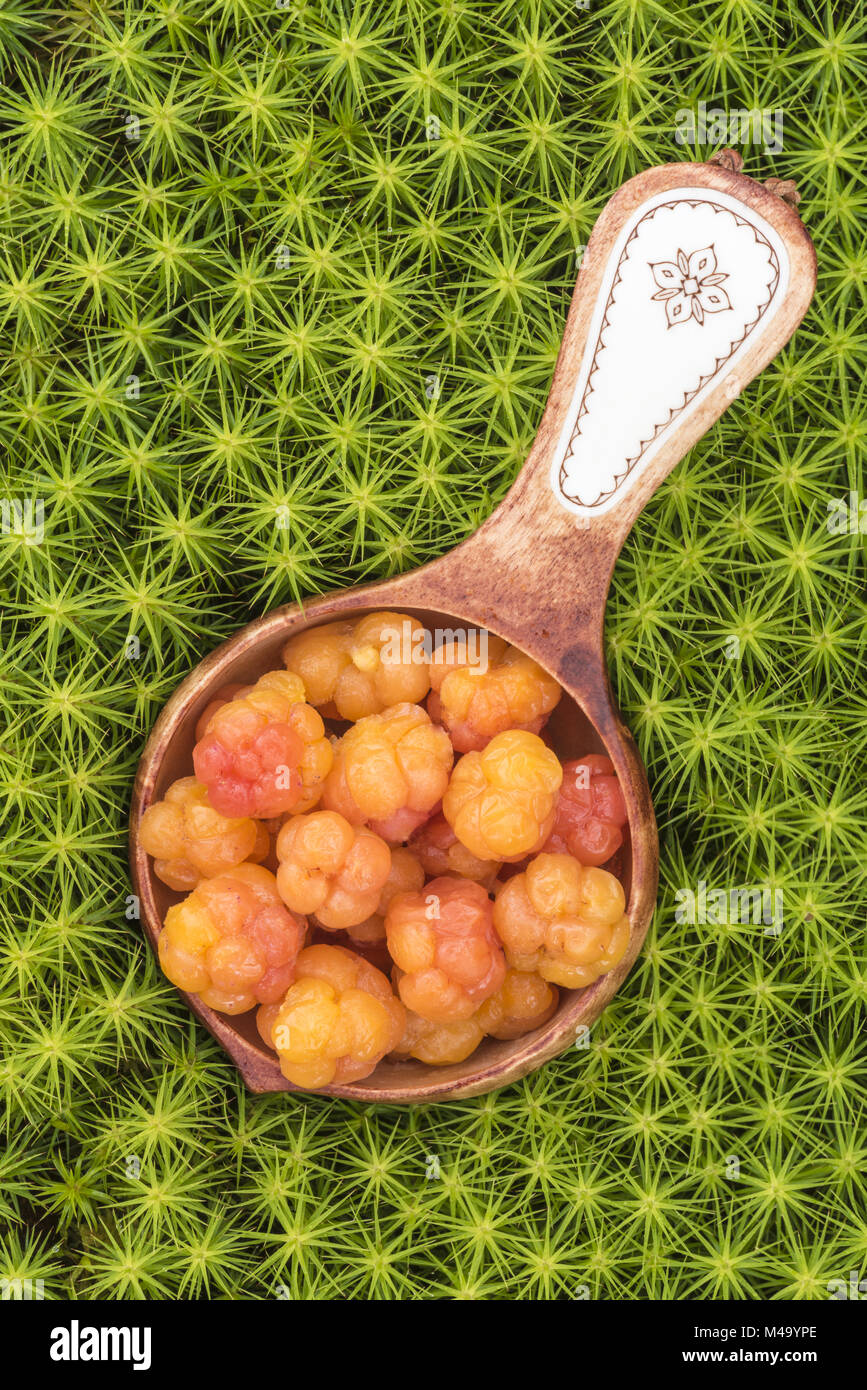 Cloudberries in a wooden bowl, Lapland, Sweden Stock Photo