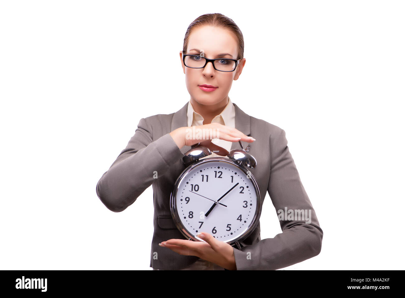 Businesswoman with giant alarm clock isolated on white Stock Photo