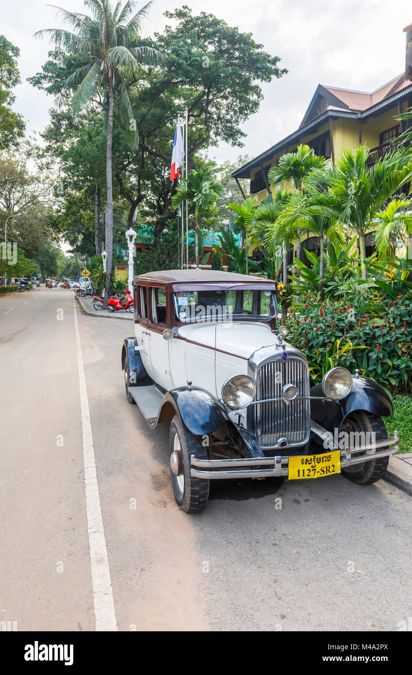 Classic light blue vintage Citroen car with large round headlights parked outside the Victoria Angkor Resort & Spa Hotel, Siem Reap, Cambodia, SE Asia Stock Photo
