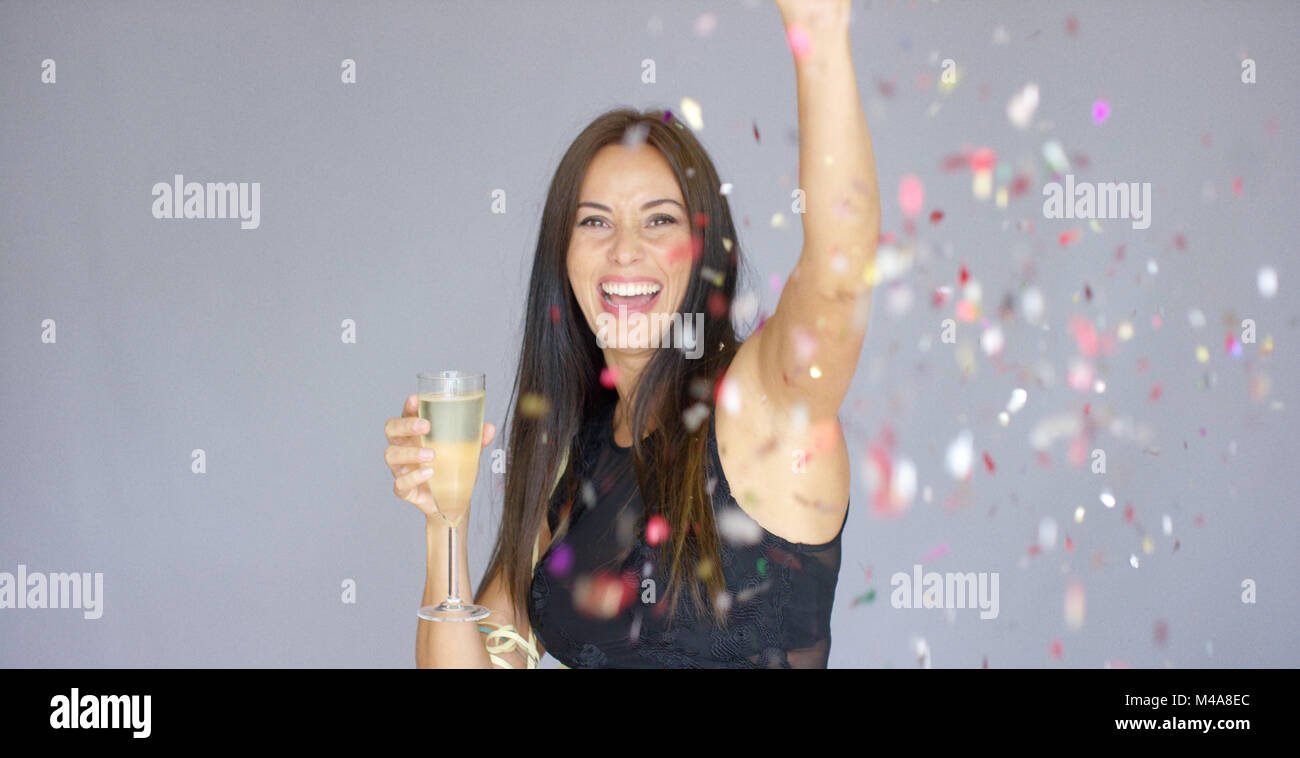 Vivacious woman having fun at a New Year party Stock Photo