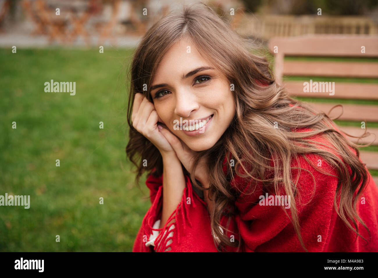 Portrait of a smiling woman resting outdoors at the park Stock Photo ...