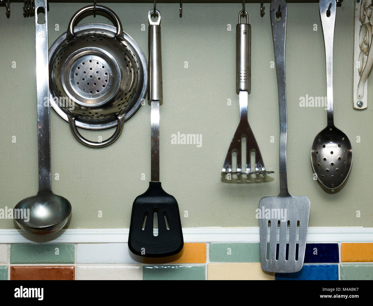 Kitchen Utensils hung up in a country cottage kitchen Stock Photo