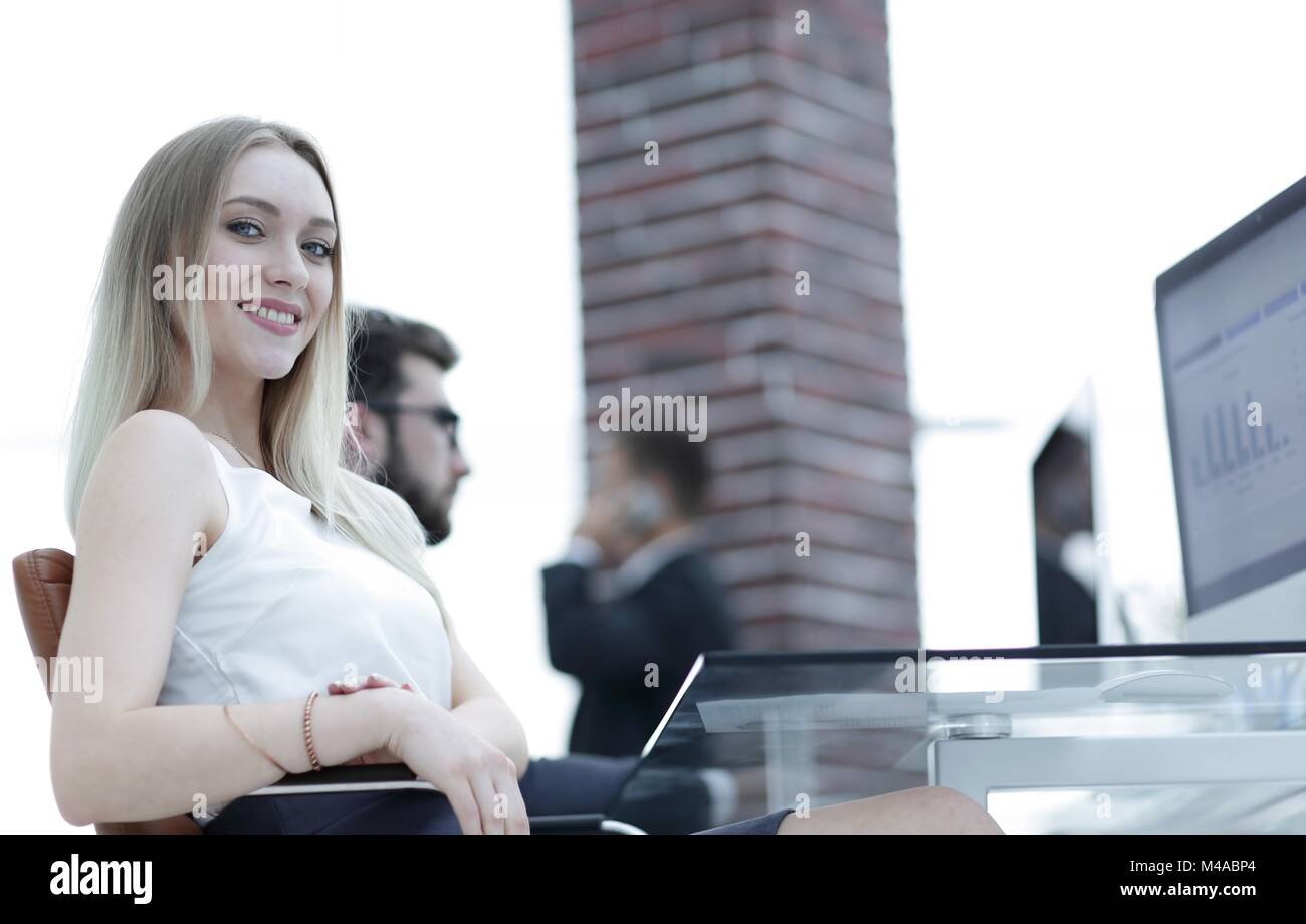 young business woman sitting at a desk in the office Stock Photo - Alamy