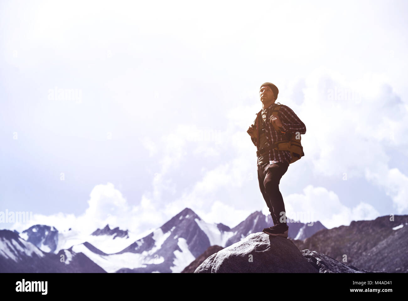 Travel adventure or trekkinng concept with single man against mountains Stock Photo