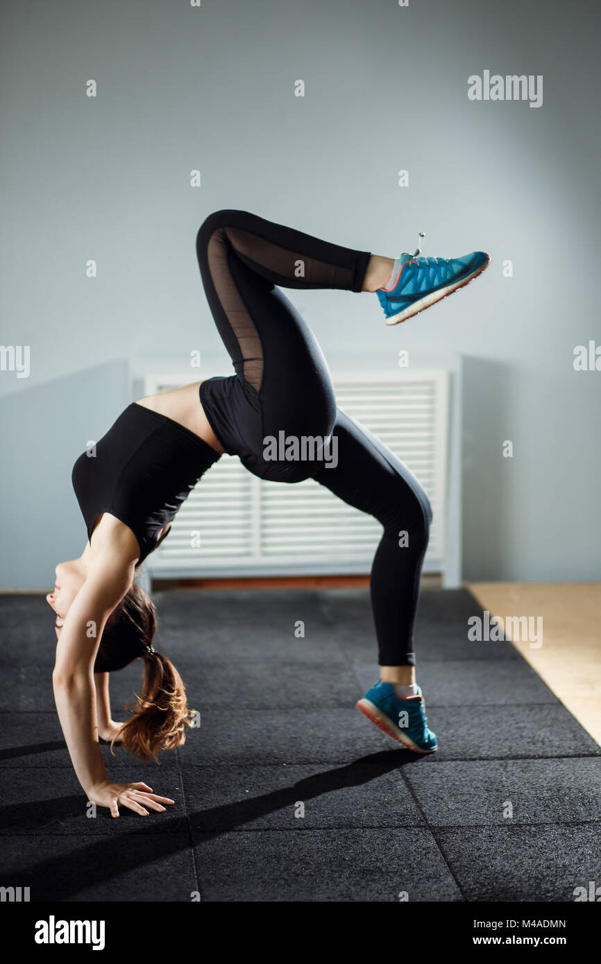 Young attractive woman in Adho Mukha Vrksasana pose, window back Stock  Photo - Alamy