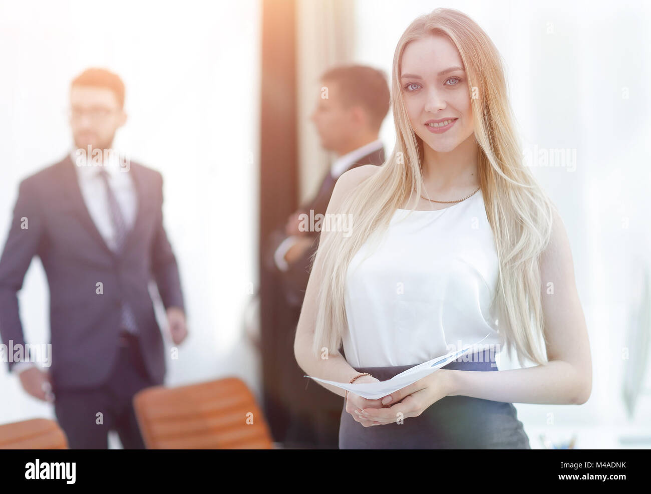 portrait of an elegant young business woman on the office backgr Stock ...