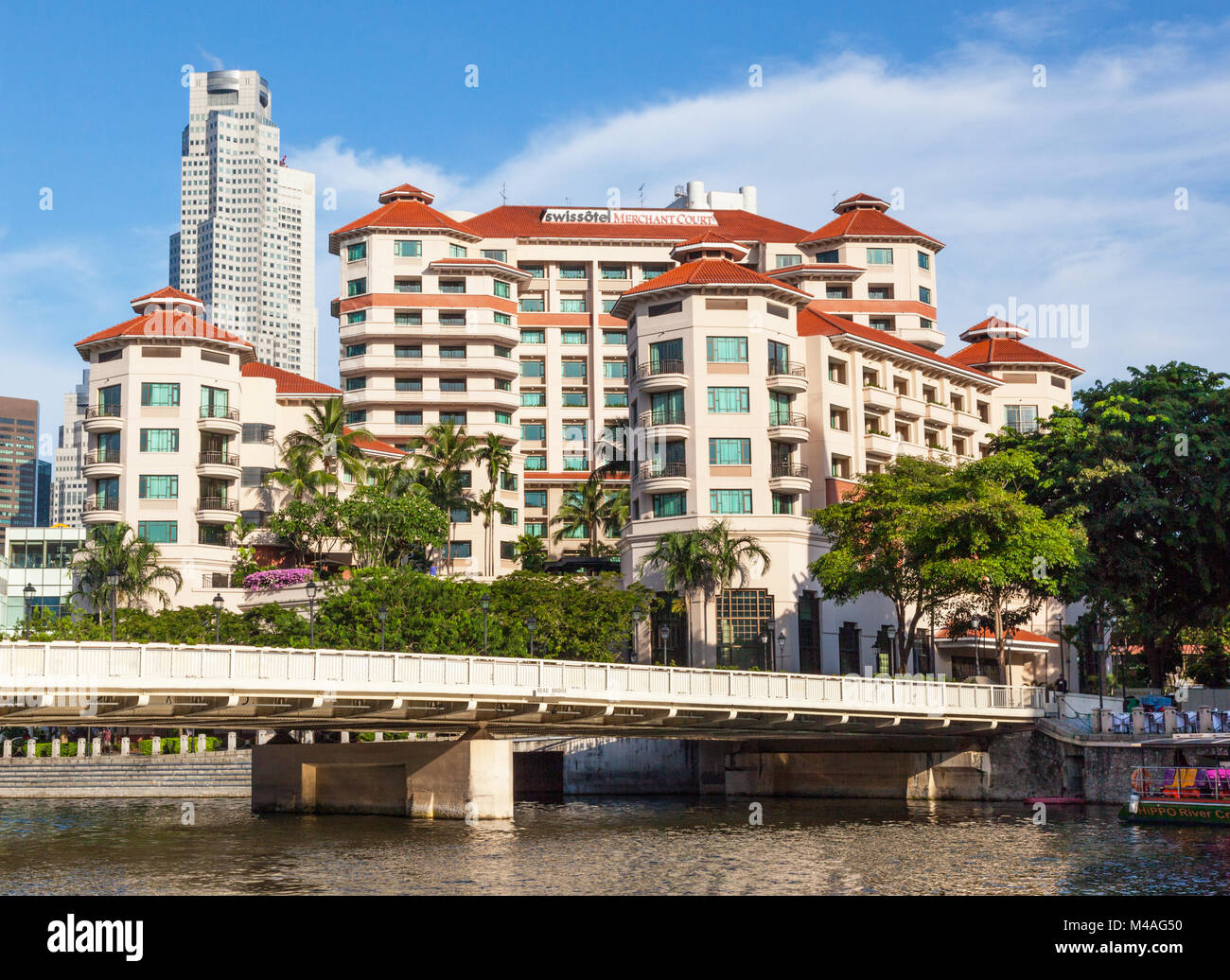 A view of the Swissotel Merchant Court Hotel in Singapore, with a bridge and the Singapore River in the foreground. Stock Photo