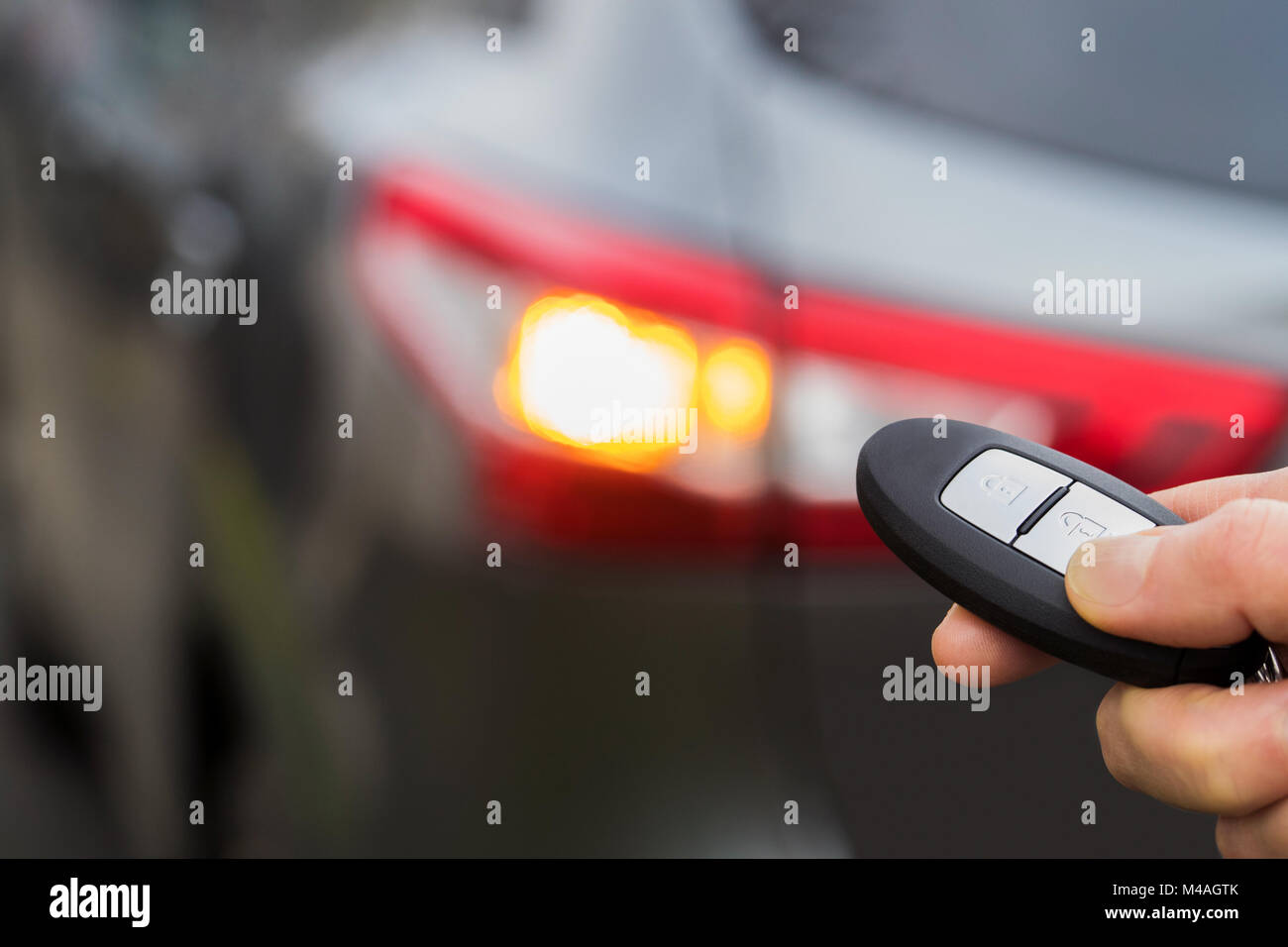 Close Up Of Driver Activating Car Security System With Key Fob Stock Photo
