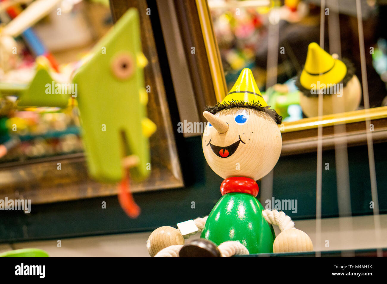 A wooden boy figure on a toy store shelf. Stock Photo