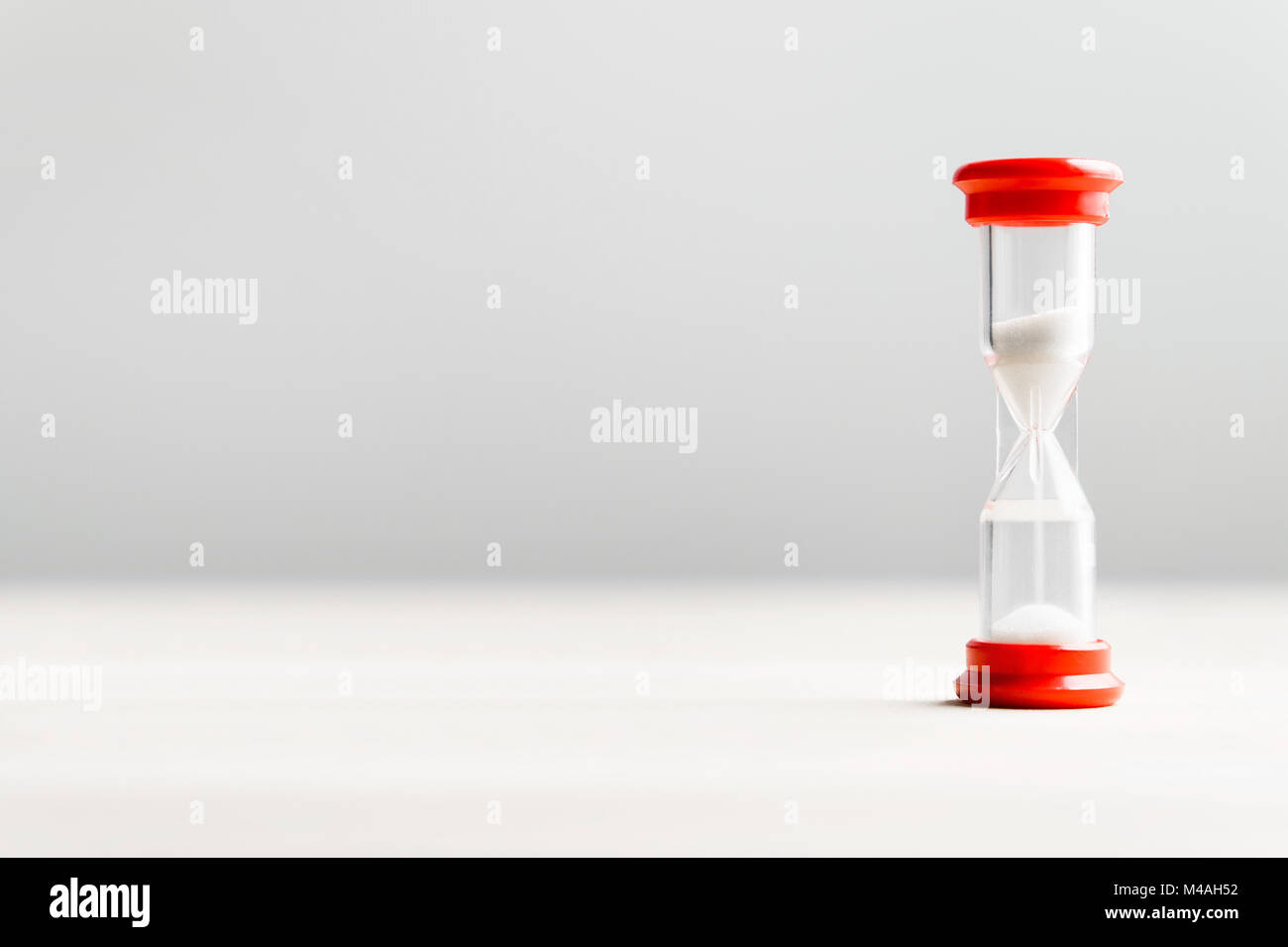 Sand in hourglass. Time passing concept with negative copy space. Stock Photo