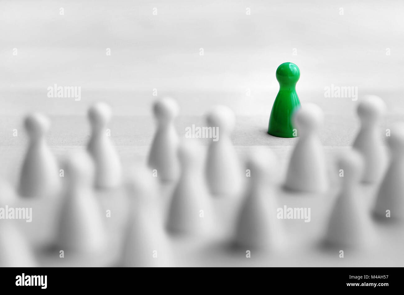 Leadership and management concept. Boss, chief or executive in front of crowd or group. Public speaking and giving presentation. Board game pawns. Stock Photo
