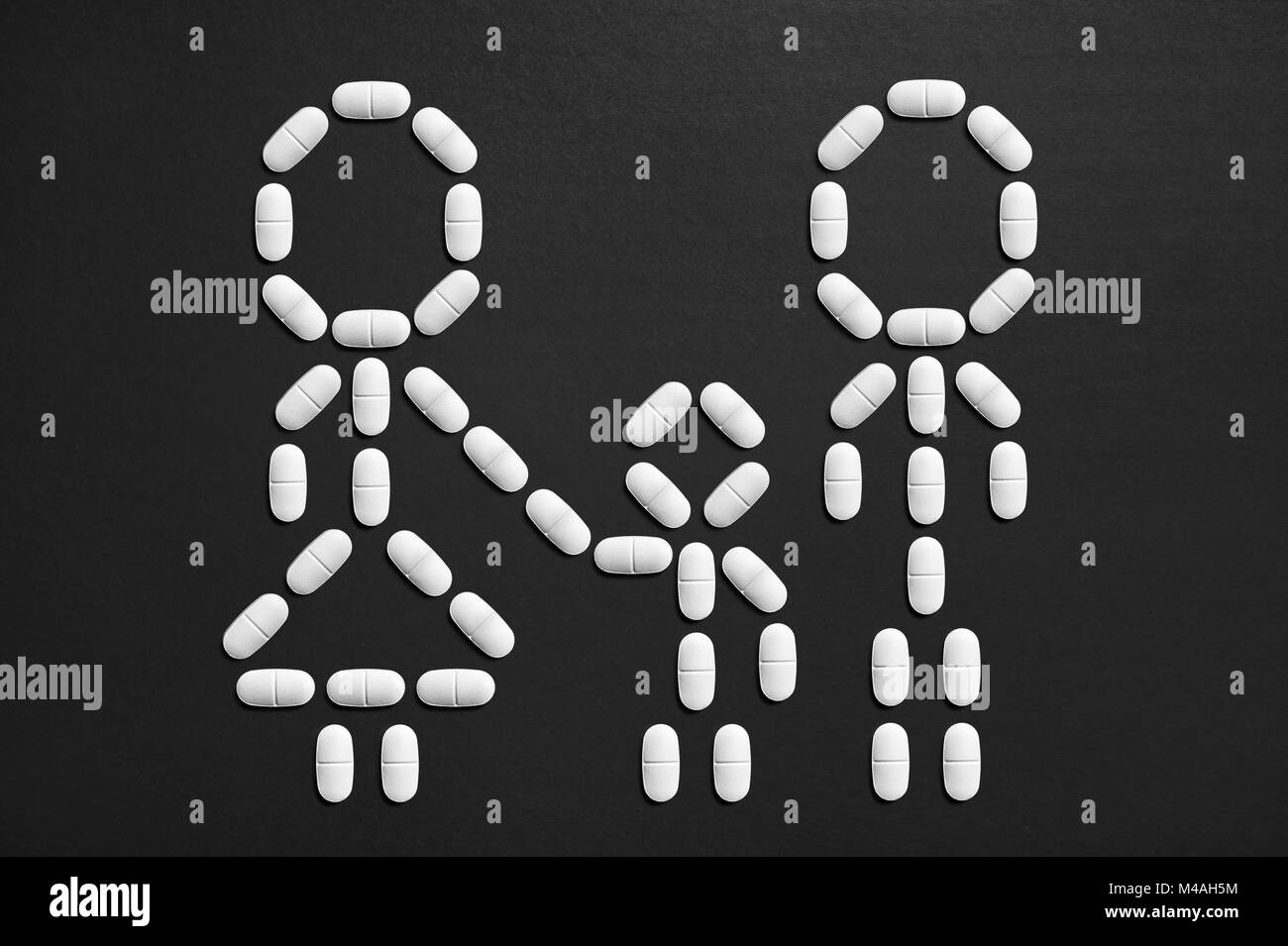 Family and kids health care. Pediatric and medical insurance concept. Stick figures made from pills. Stock Photo