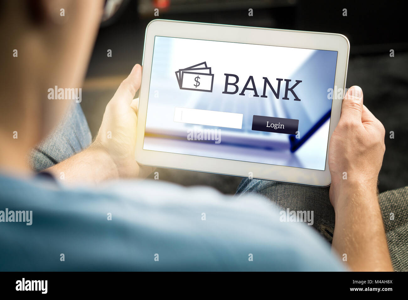 Man using mobile bank application with tablet and smart device at home. Login page to personal account. Online internet banking. Stock Photo