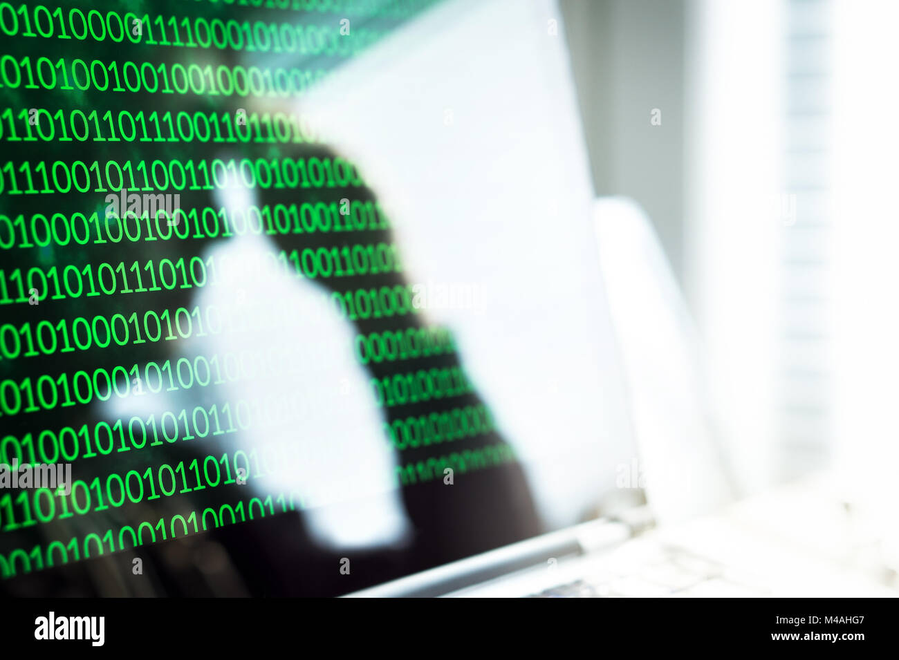 Cyber bullying, online fraud or computer virus concept. Reflection of sad, depressed and frustrated man or teen leaning head on hand in laptop screen. Stock Photo