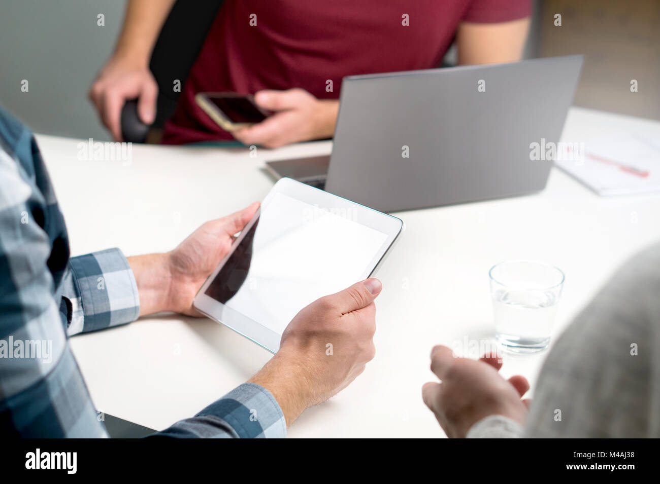 Small business, start up or marketing team working together and having meeting. Workstation with modern technology. Happy casual business people. Stock Photo
