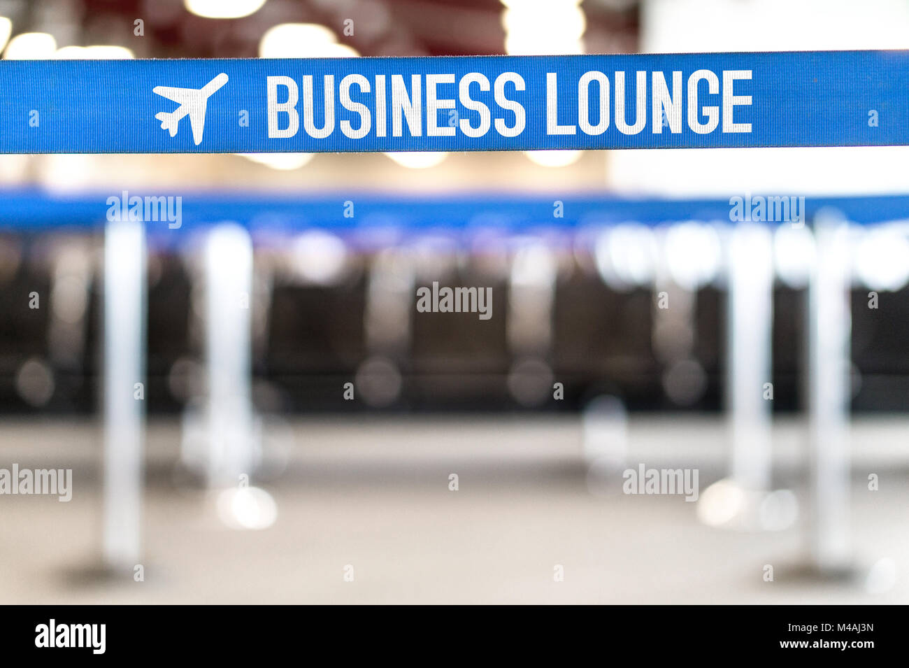 Business lounge at airport. Vip waiting area at terminal with seats in a row. Airport waiting room at terminal. Empty bench at gate. Stock Photo