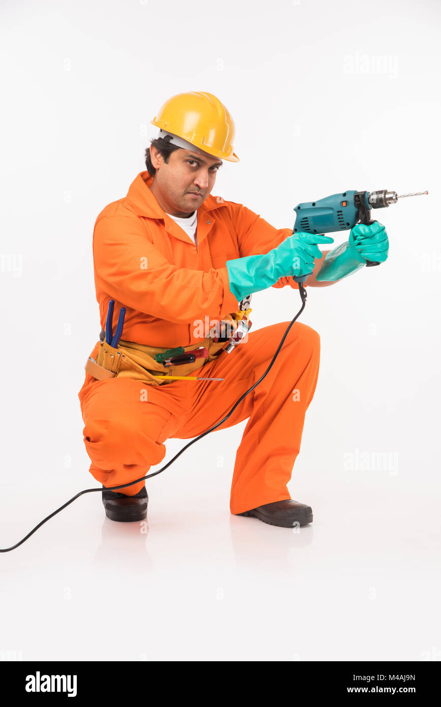Indian electrician engineer in action with wire cutter, drilling ...