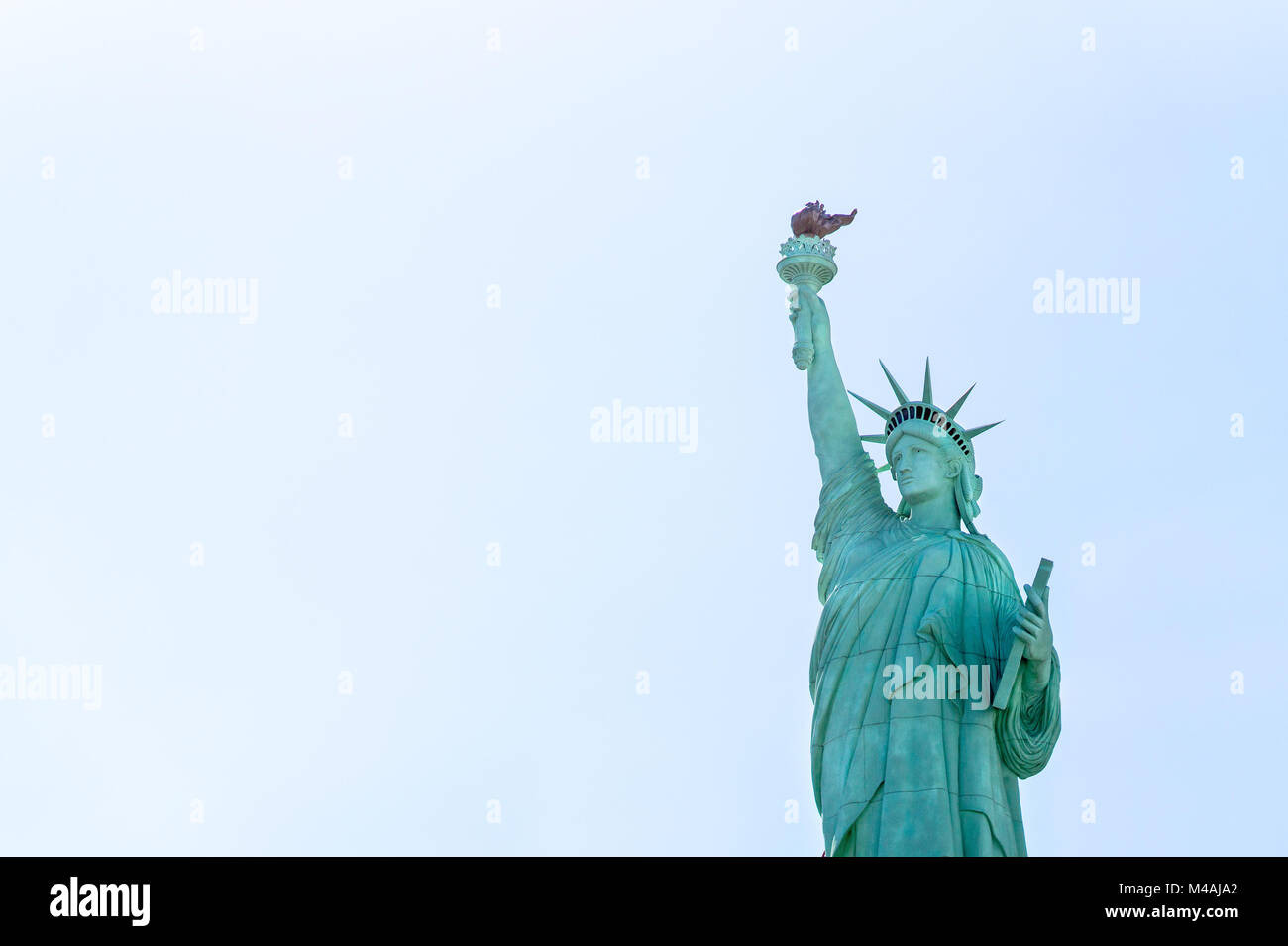 Statue of Liberty against blue sky with negative copy space. Stock Photo