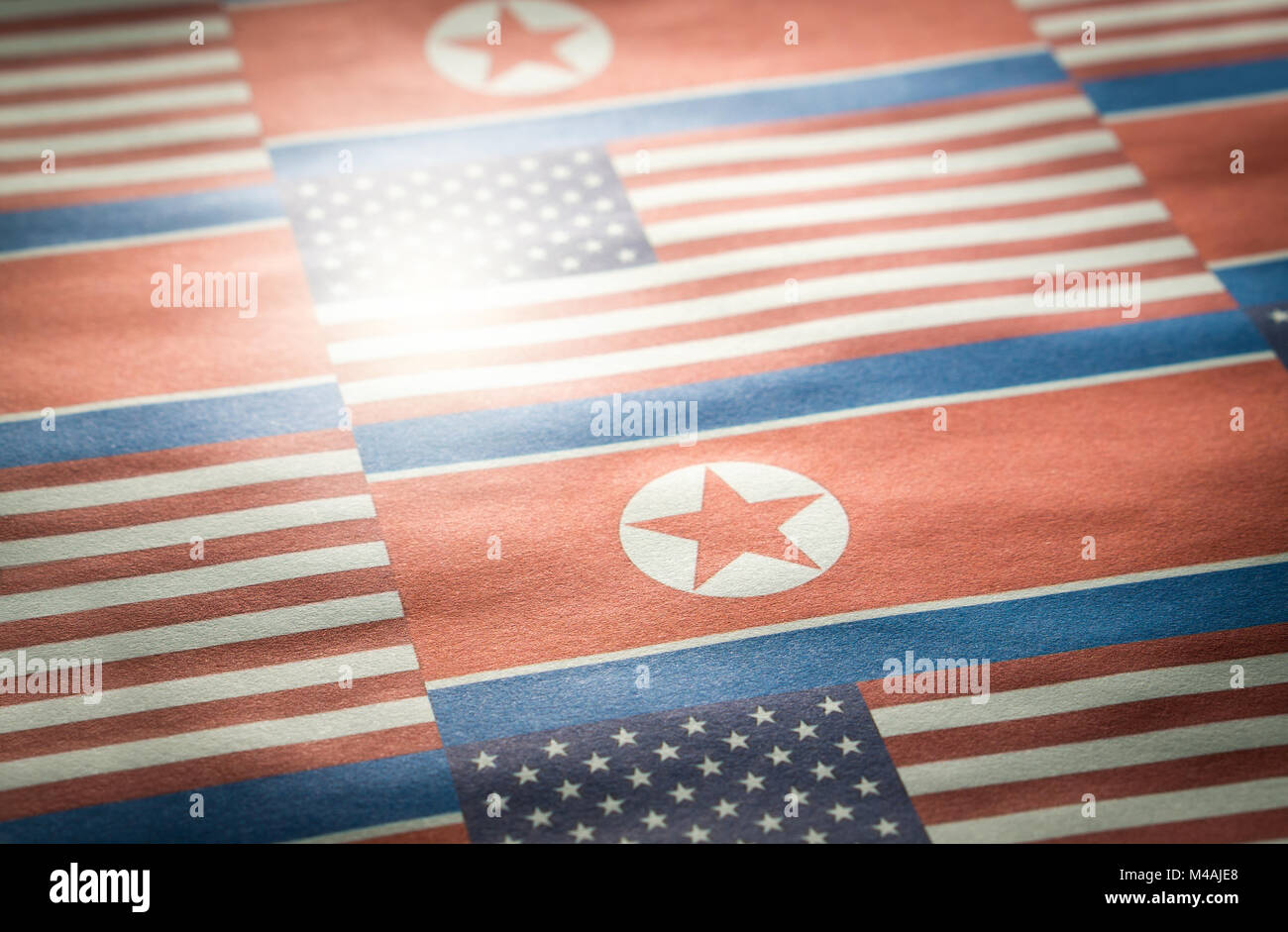 The flag of North Korea and United States of America (USA) on a wrinkled rough paper texture. Stock Photo