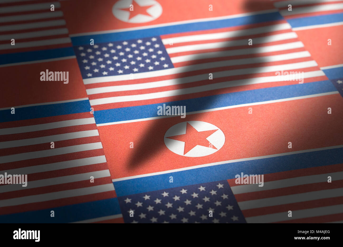 The flag of North Korea and United States of America (USA) with a shadow from a ballistic missile. Stock Photo