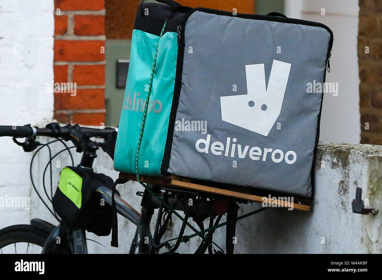 A Deliveroo food delivery box sits on the back of a bicycle as the