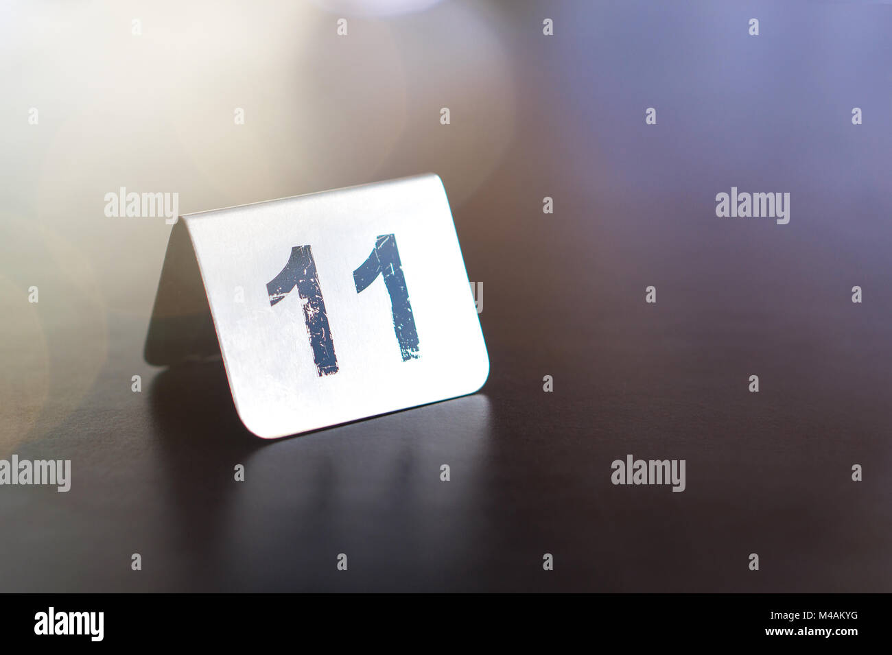 Number sign on restaurant table to show reservation. Customer waiting for service or food. Stock Photo