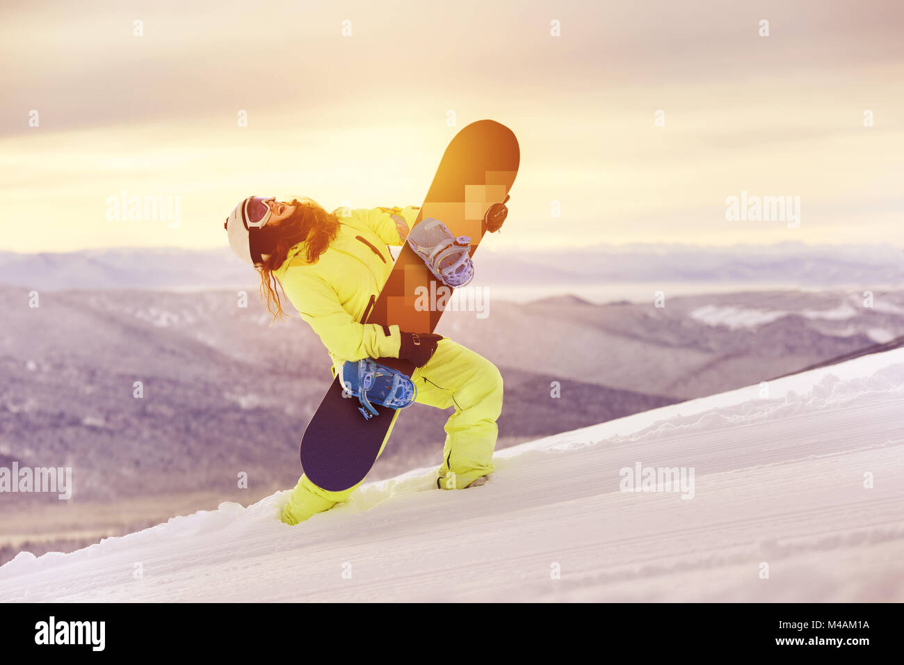 Happy lady snowboarder having fun with snowboard Stock Photo