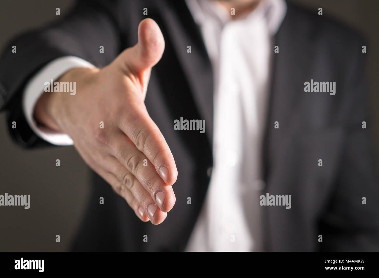 Business man offer and give hand for handshake. Salesman or real estate agent shake for deal, agreement or sale. Partnership, recruitment, acquisition Stock Photo