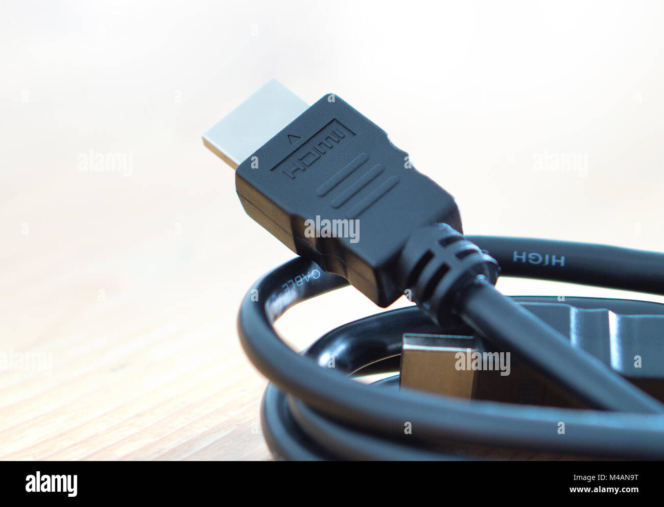 HDMI cable on wooden table at home. Stock Photo