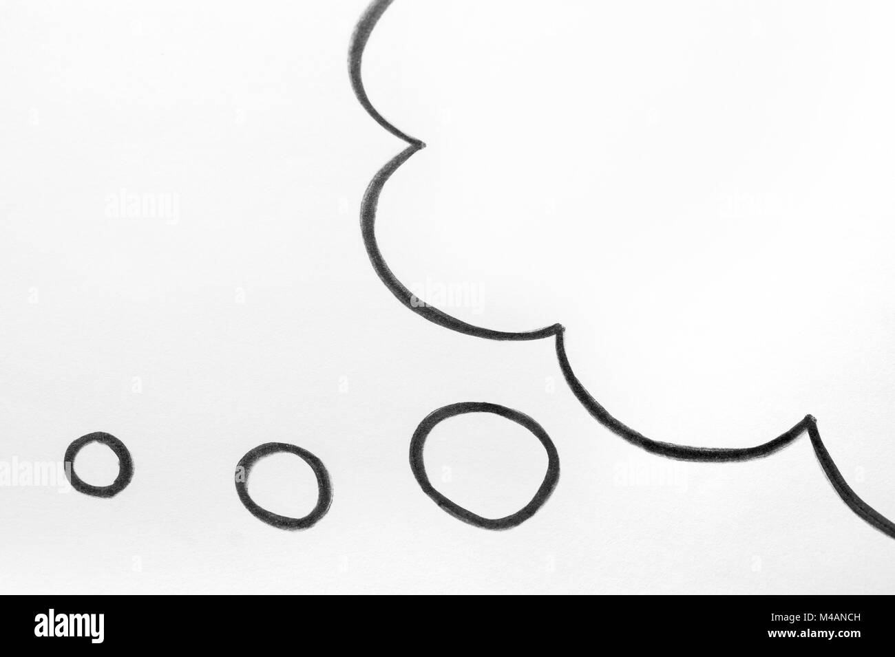 Thought cloud and thinking speech bubble balloon hand drawn on paper. Stock Photo